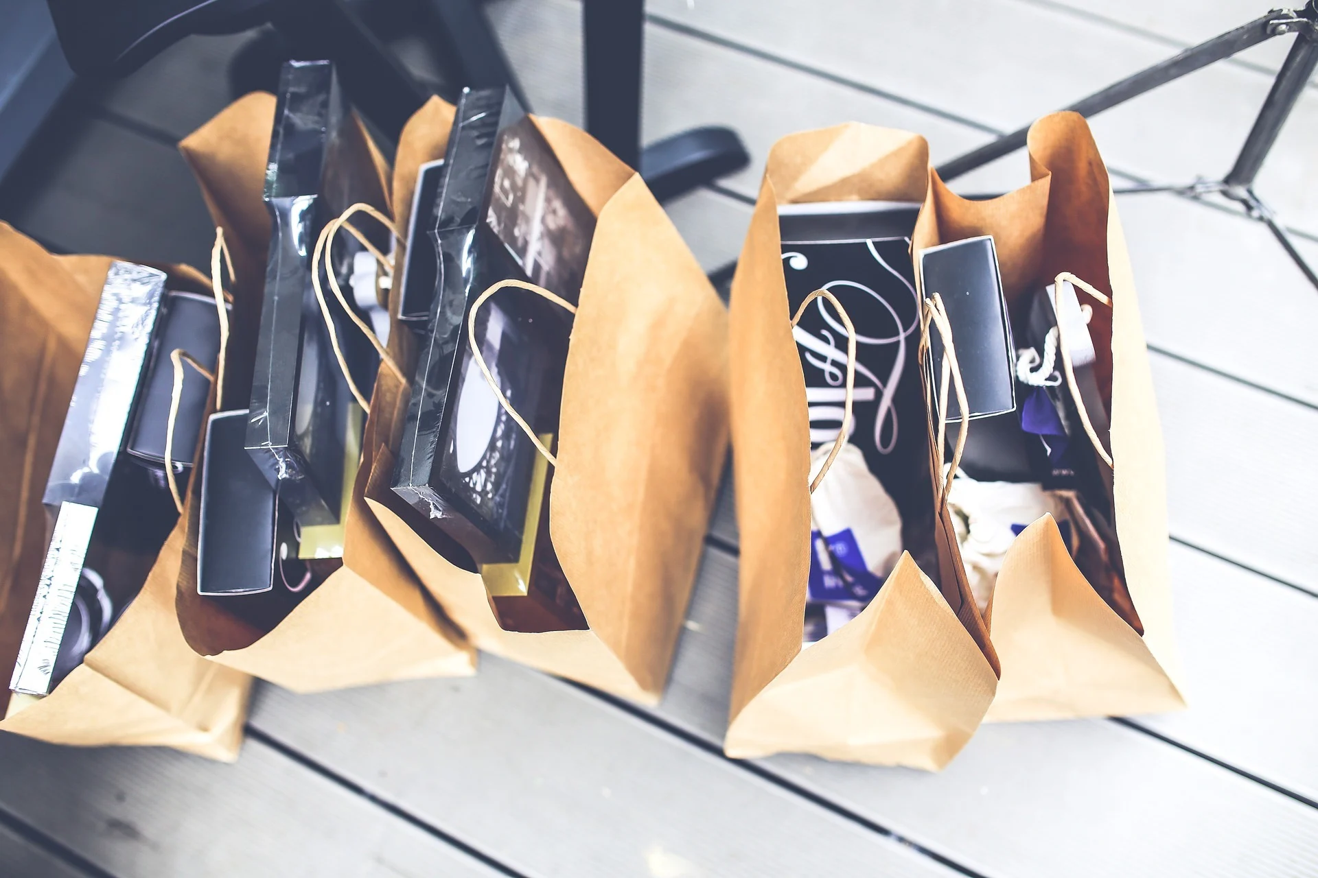 A row of paper shopping bags on the floor