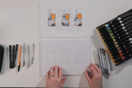 A top down view of a desk with an empty three-box template adjacent to three rendered designs.