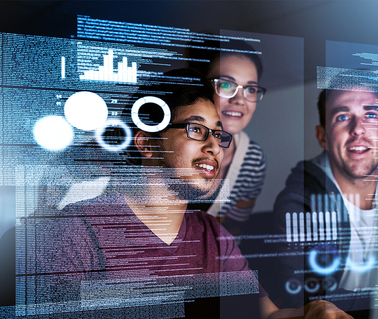 Three people looking at screens of data smiling.