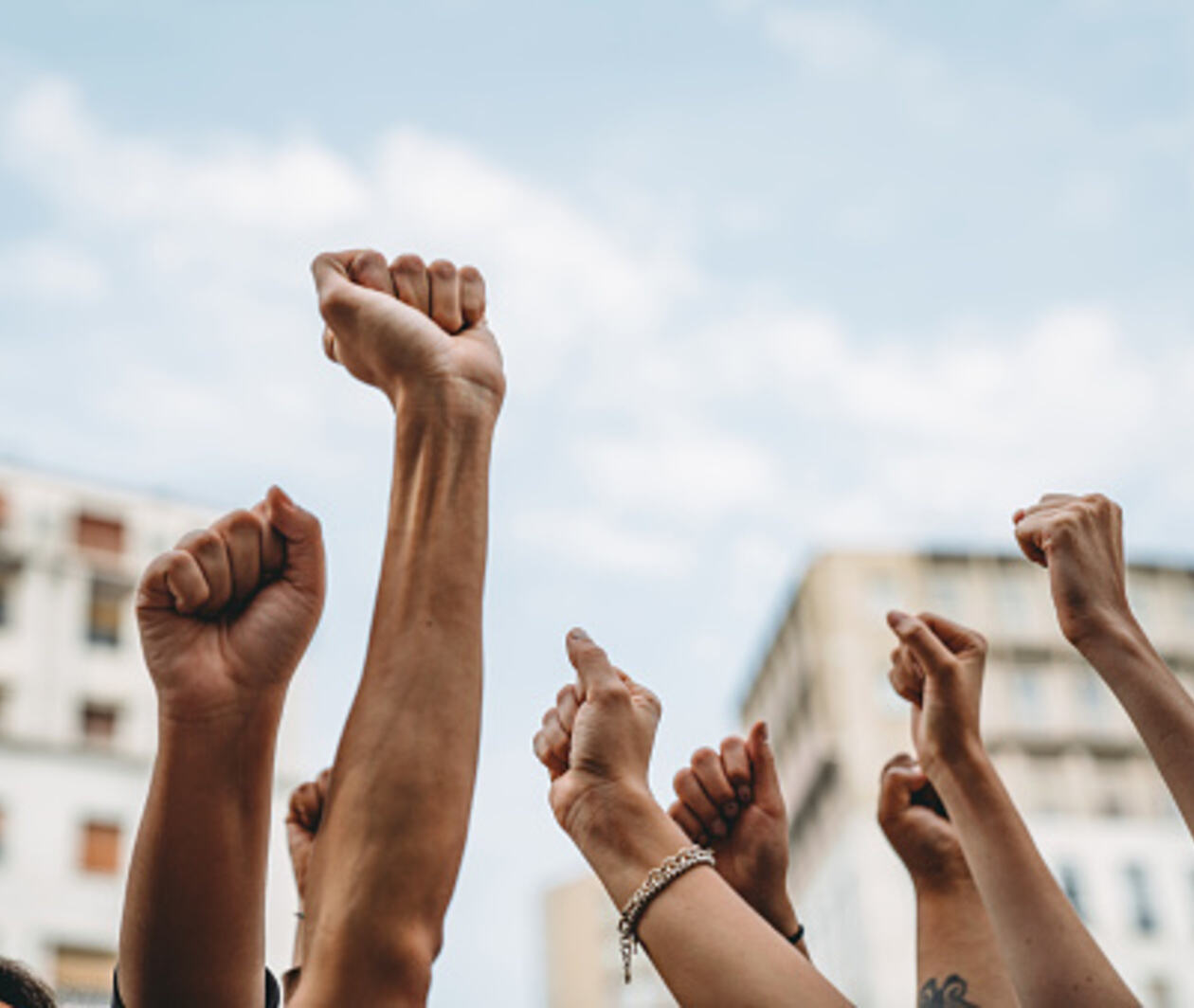 People with raised fists at a demonstration in the city