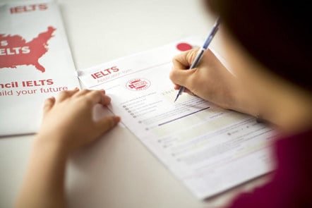 Somebody completing an IELTS application form