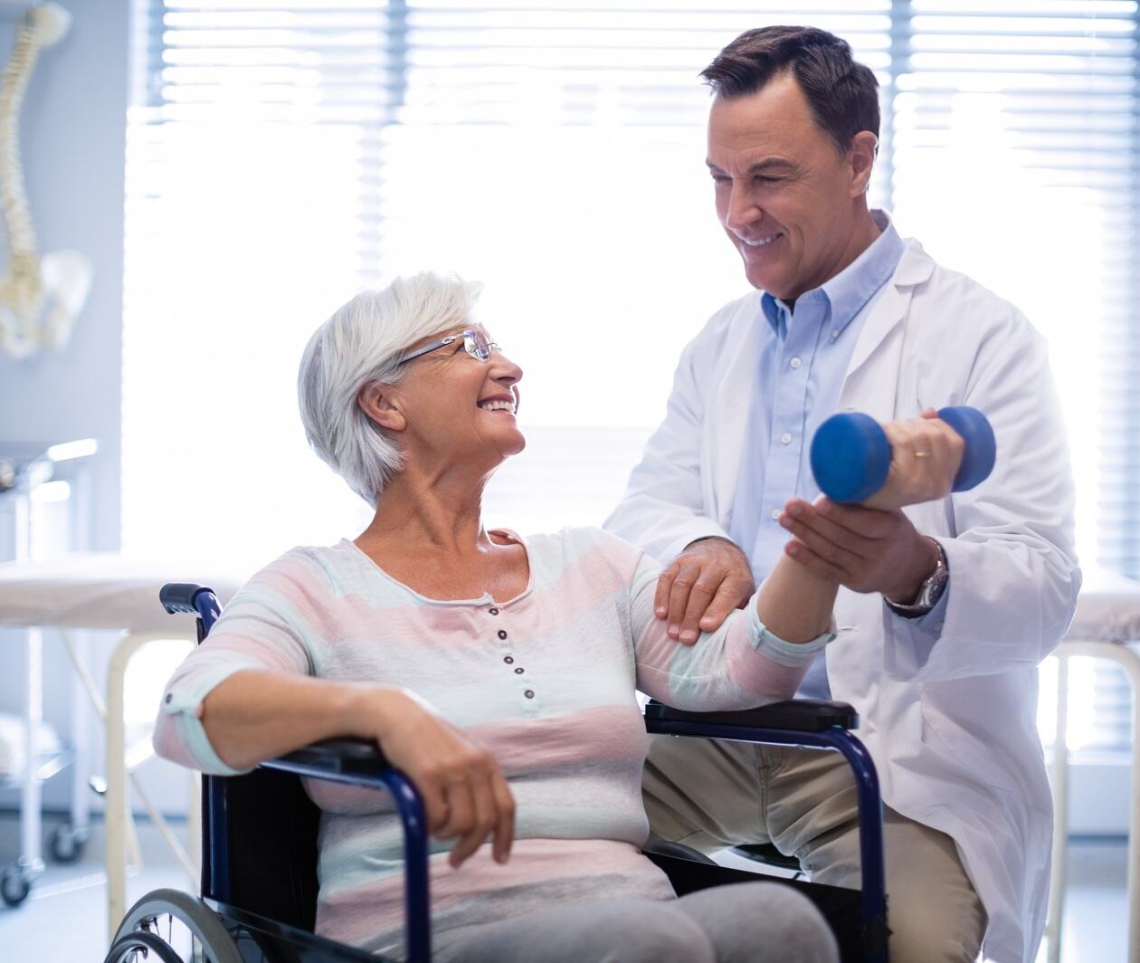 Physiotherapist assisting senior patient with hand exercise as part of an exercise prescription