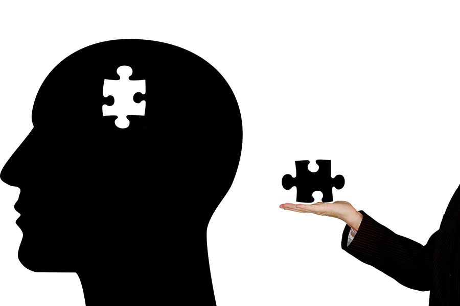 hand holding puzzle piece missing from brain