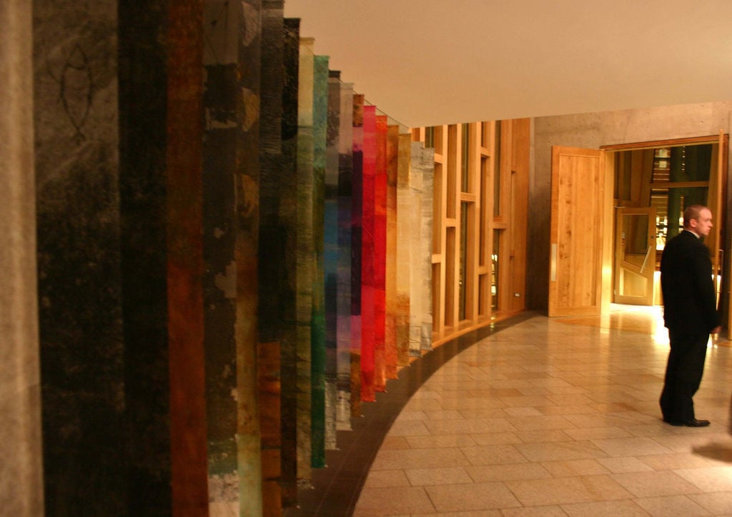 Hanging panels of colourful artwork in a corridor of the Scottish Parliament