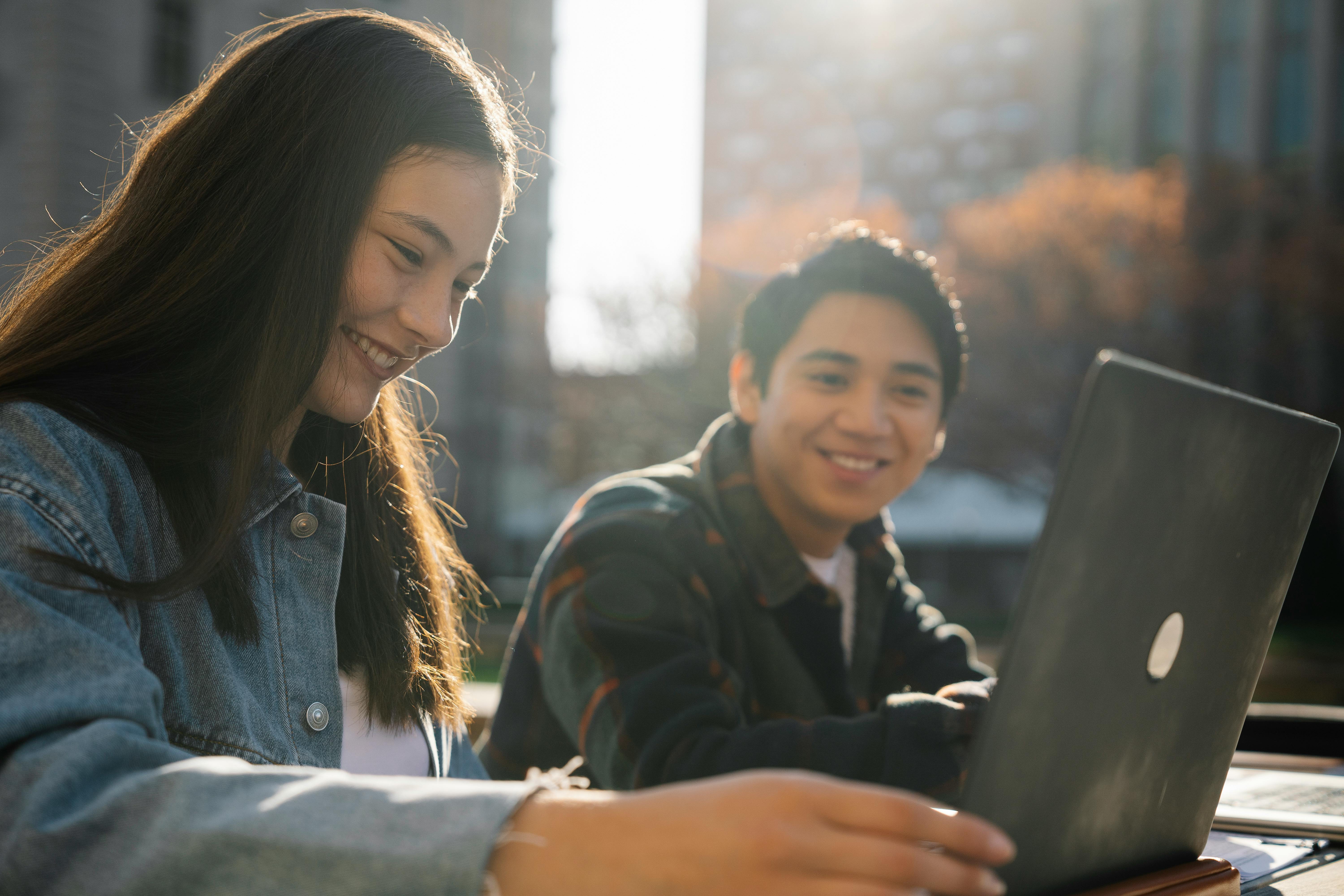 The future of education isn’t somewhere else. It is already unfolding in everyday classroom learning. Two students looking at a laptop together