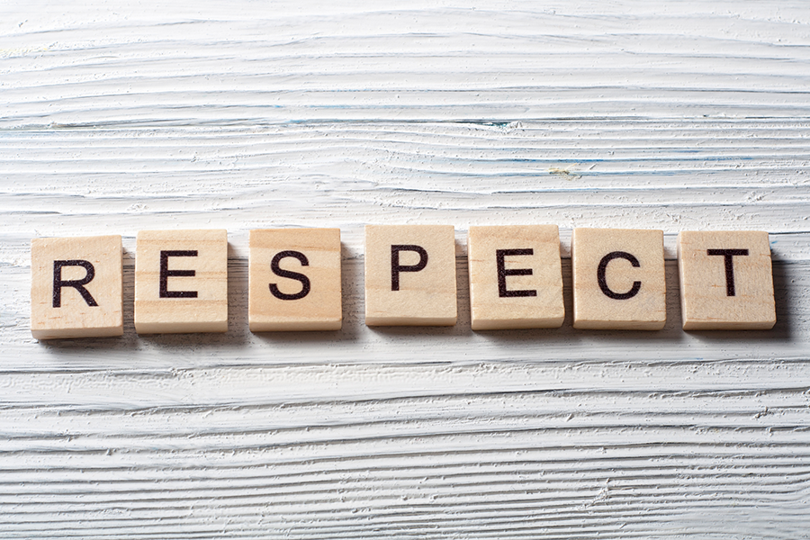 Wooden tiles are laid out to spell the word ‘respect’