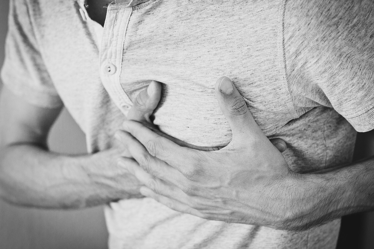 Man holding chest by heart