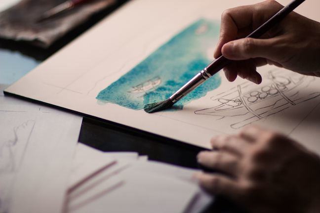 A person paints the sea