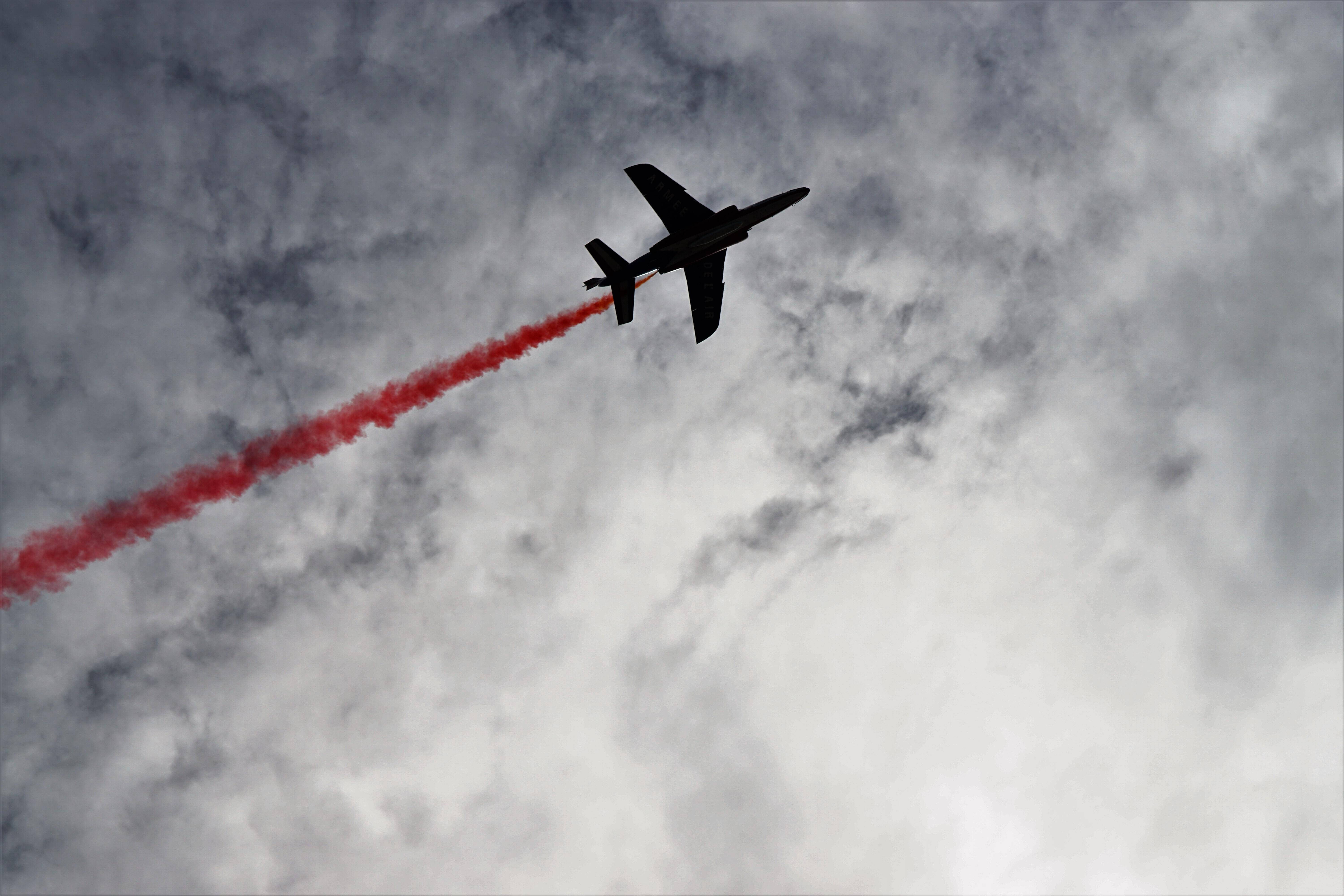 A plane leaving a red trail in the sky