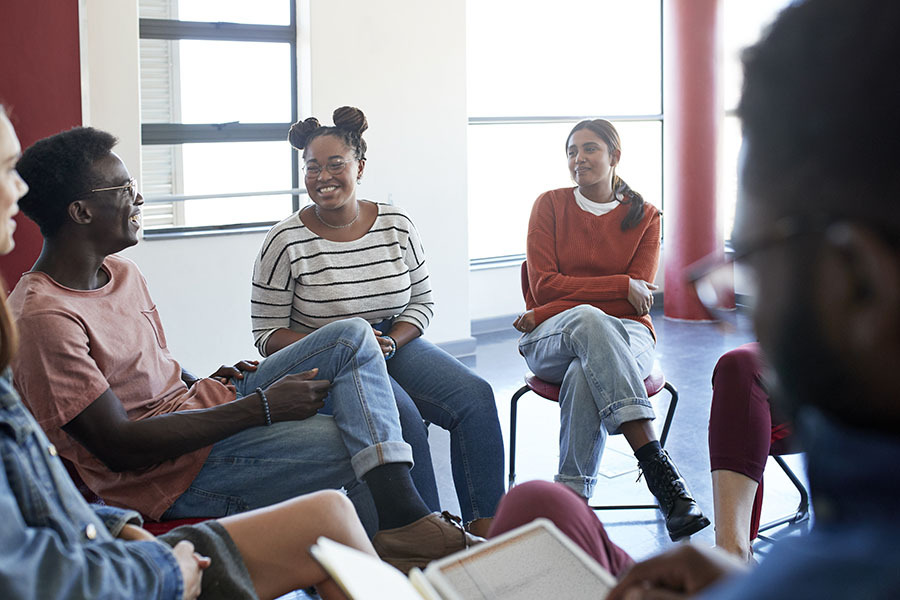 Group of young people in a circle talking