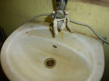 An image of a dirty sink and tap is shown.