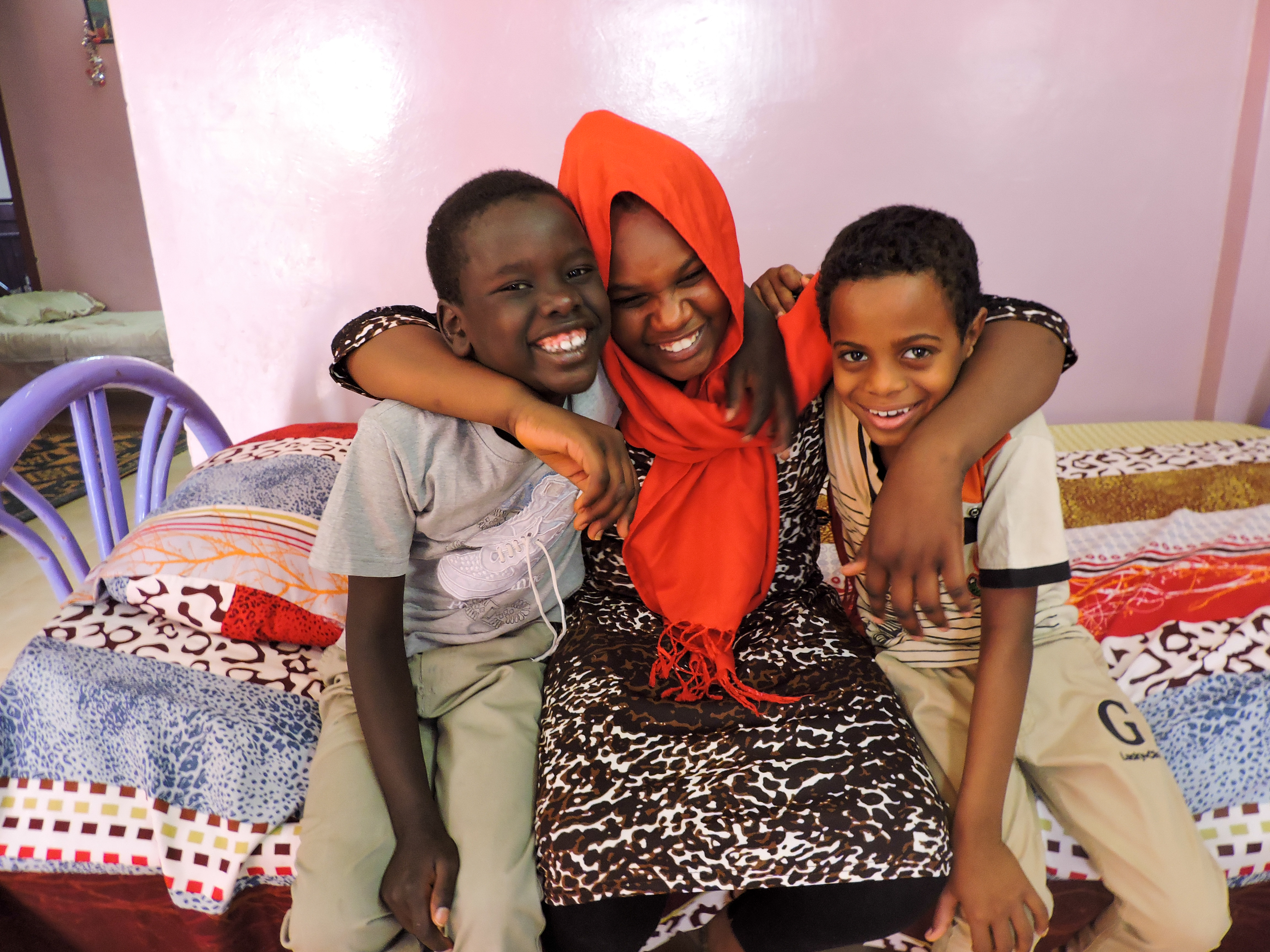 Woman and two boys hugging