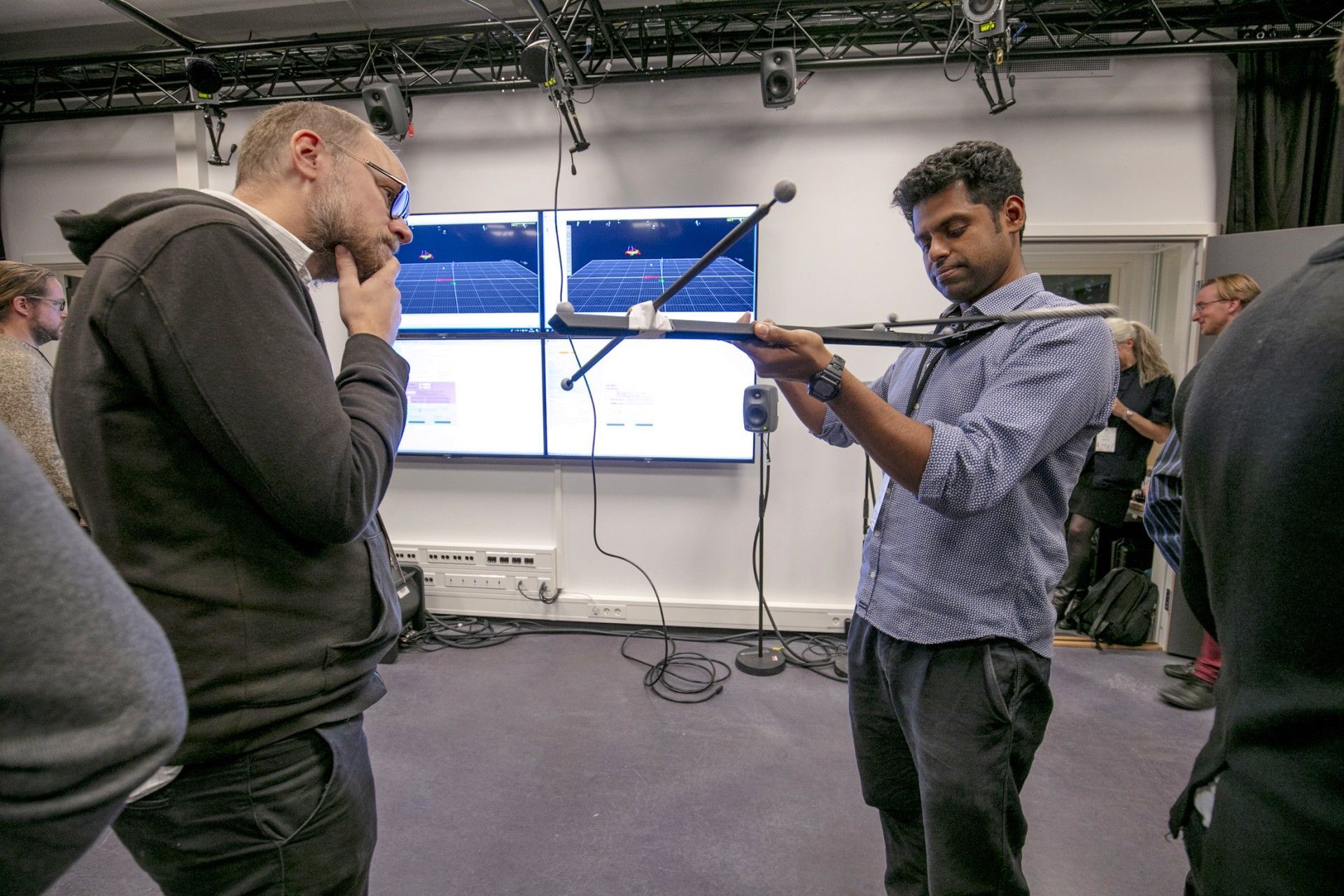 People examining motion capture equipment.