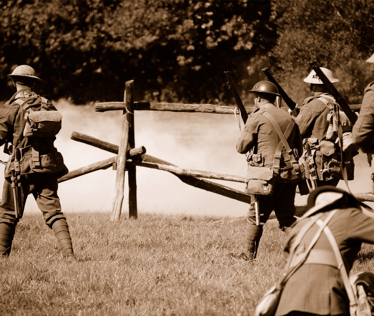 Re-enactors of the first world war (British troops)advance towards enemy troops