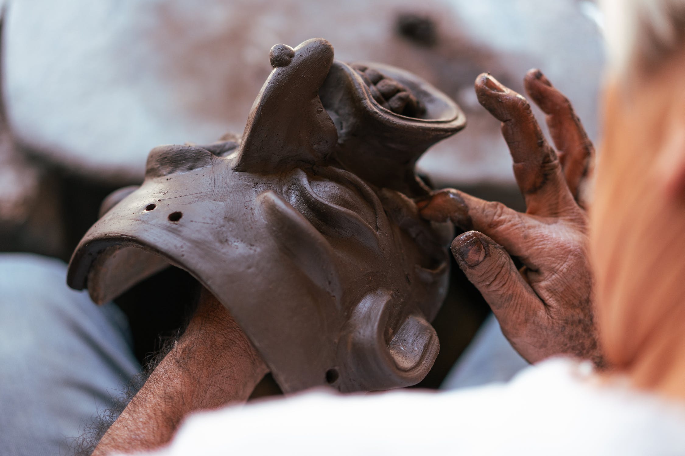 Person Holding Brown Wooden Animal Figurine