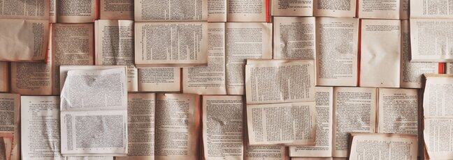 Overhead view of pages from books arranged geometrically
