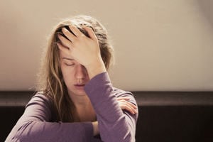 Young girl with her head in her hands