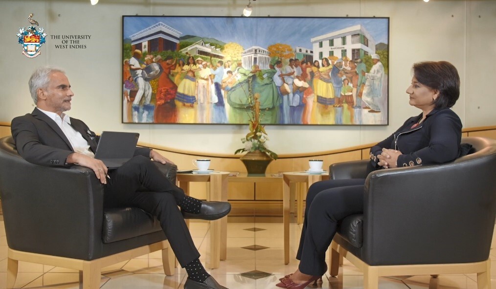 Karen Darbasie and Professor Sterling K Frost sitting across from one another in conversation