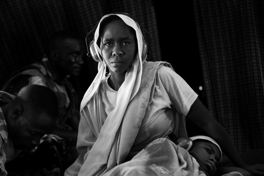 photograph of woman in a UN military helicopter, the survivor of an attack on the village of Wadda, 2009