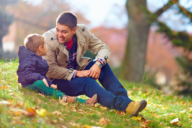 Man and boy talking happily