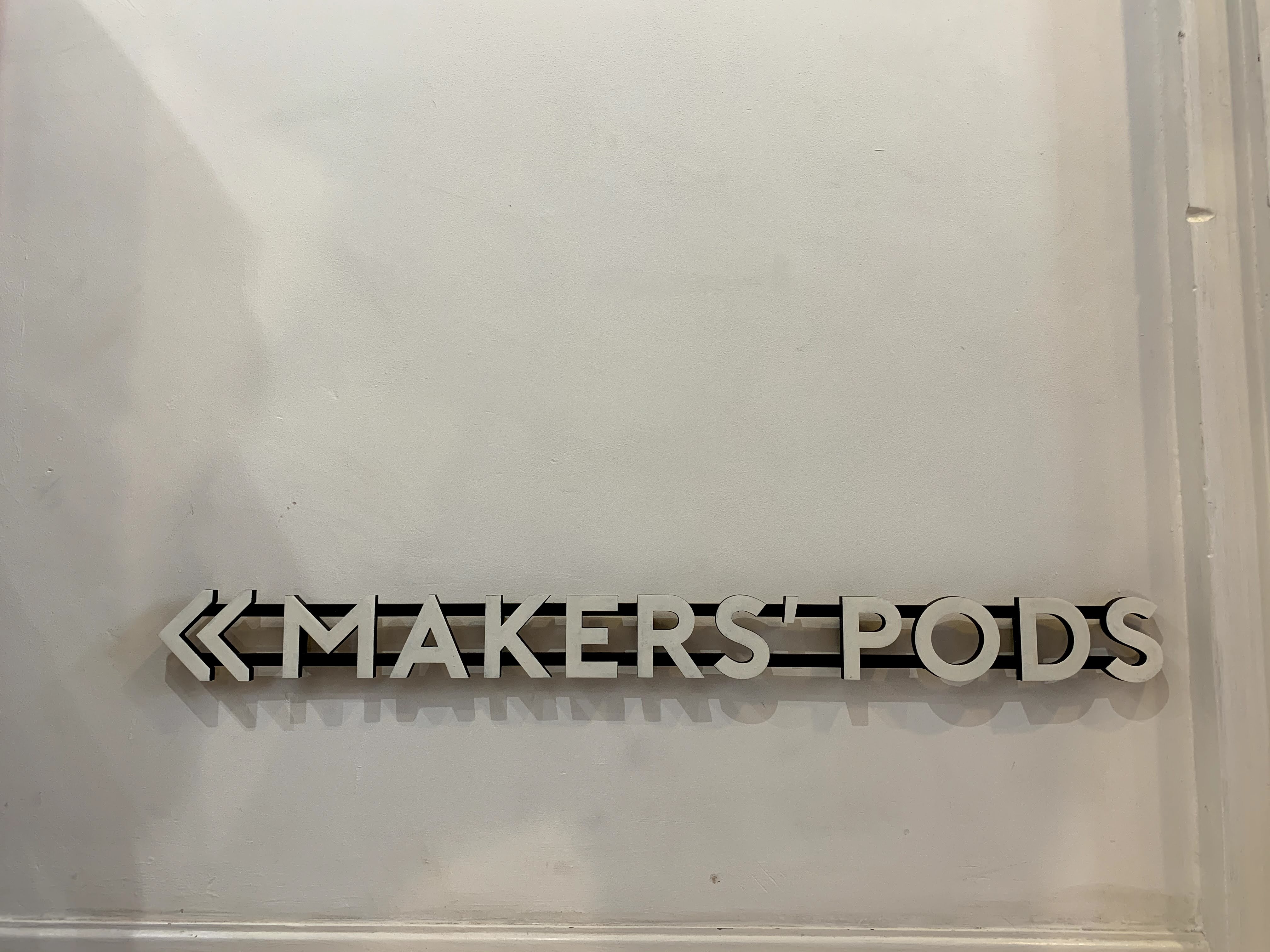 A sign advertises 'maker pods'