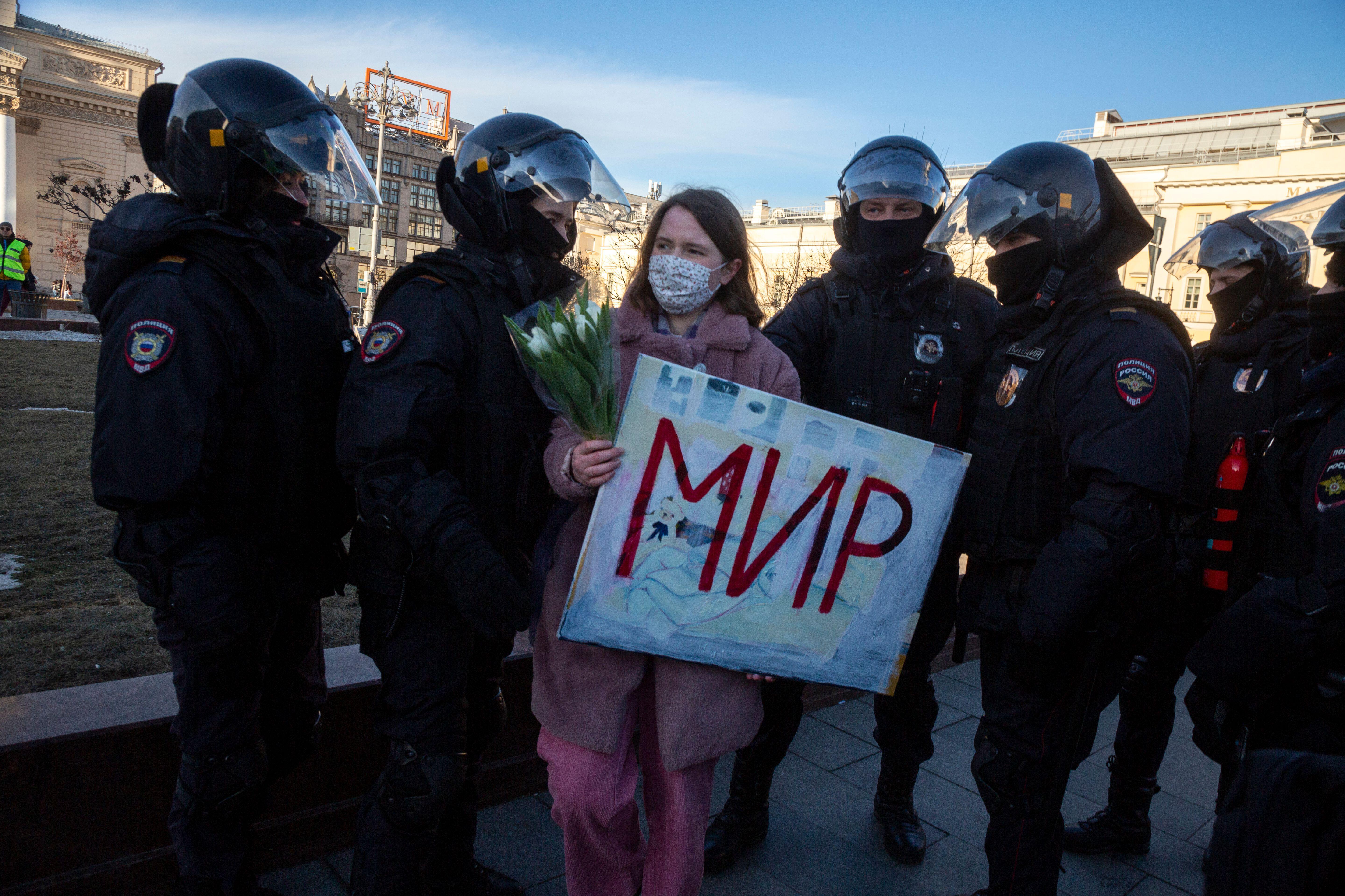 Riot police detain an anti-war protester in Moscow, March 2022