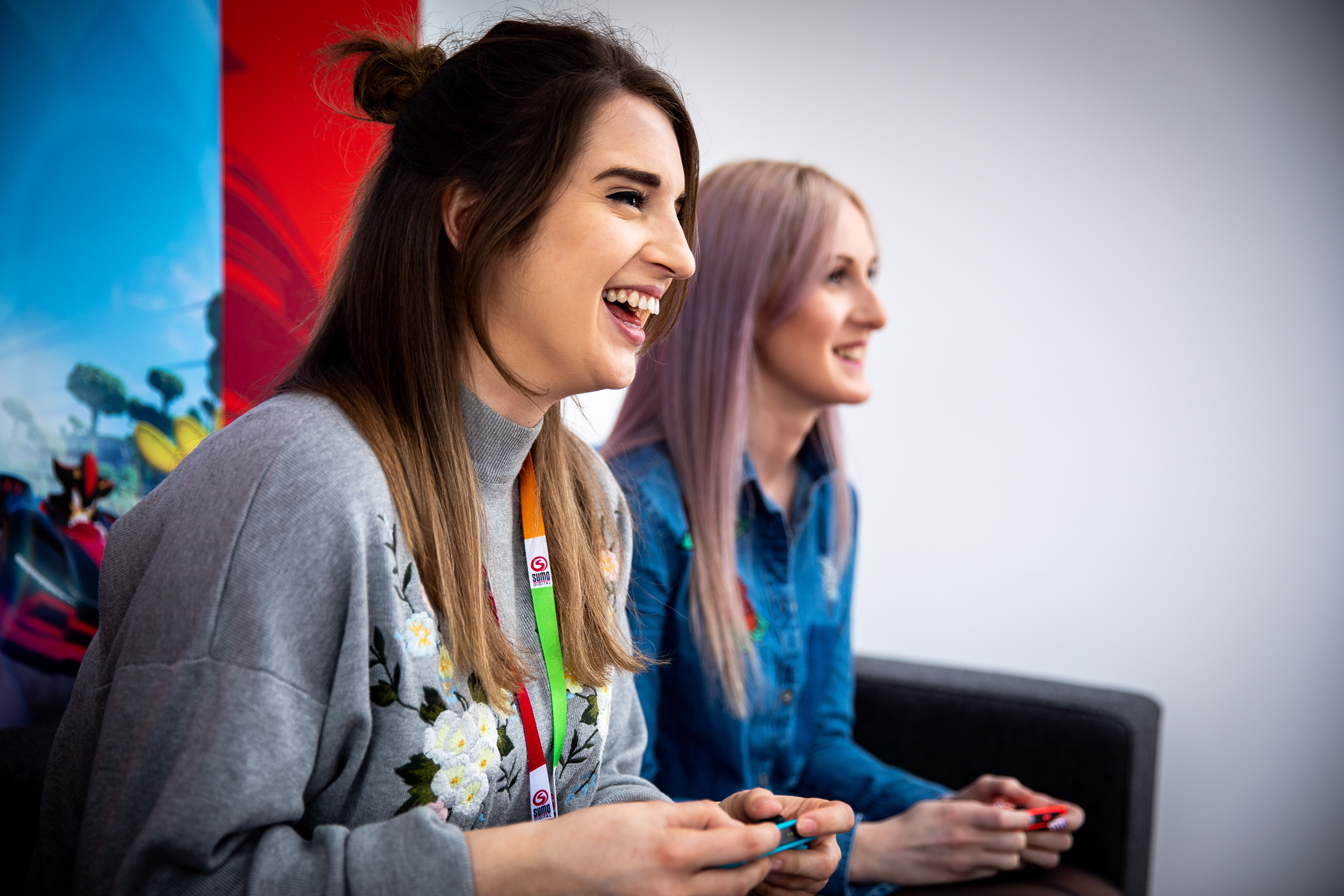 Three people looking at a screen