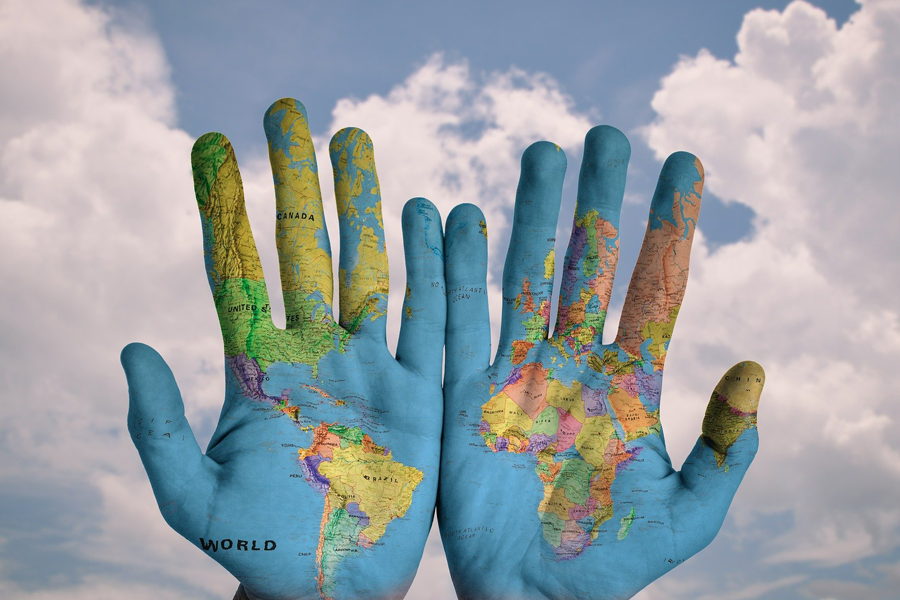 Hands painted with world map