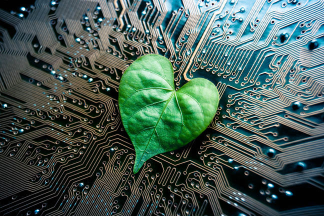 A green leaf with a heart shape on a computer circuit board