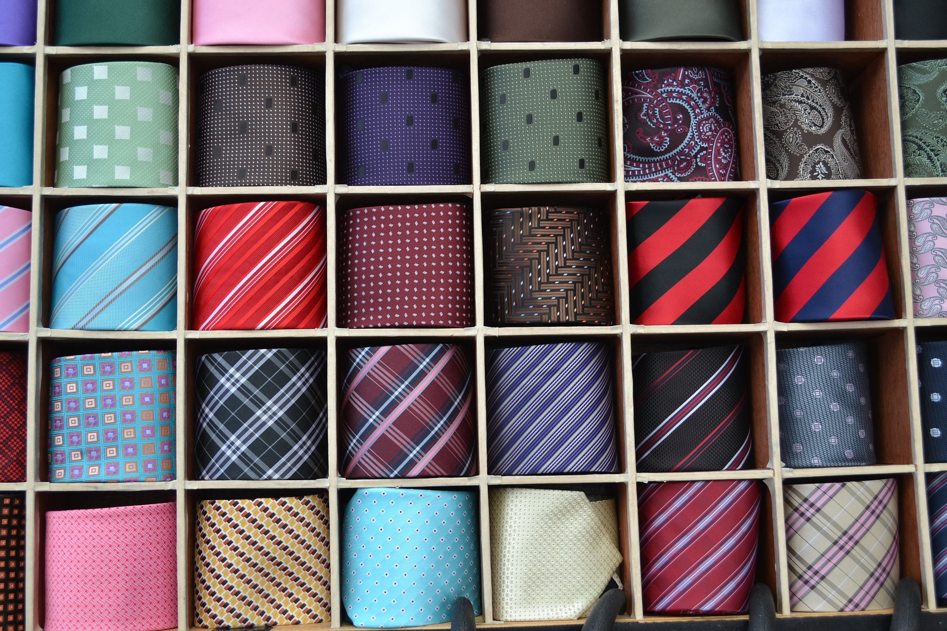 a shelf with different coloured men's ties