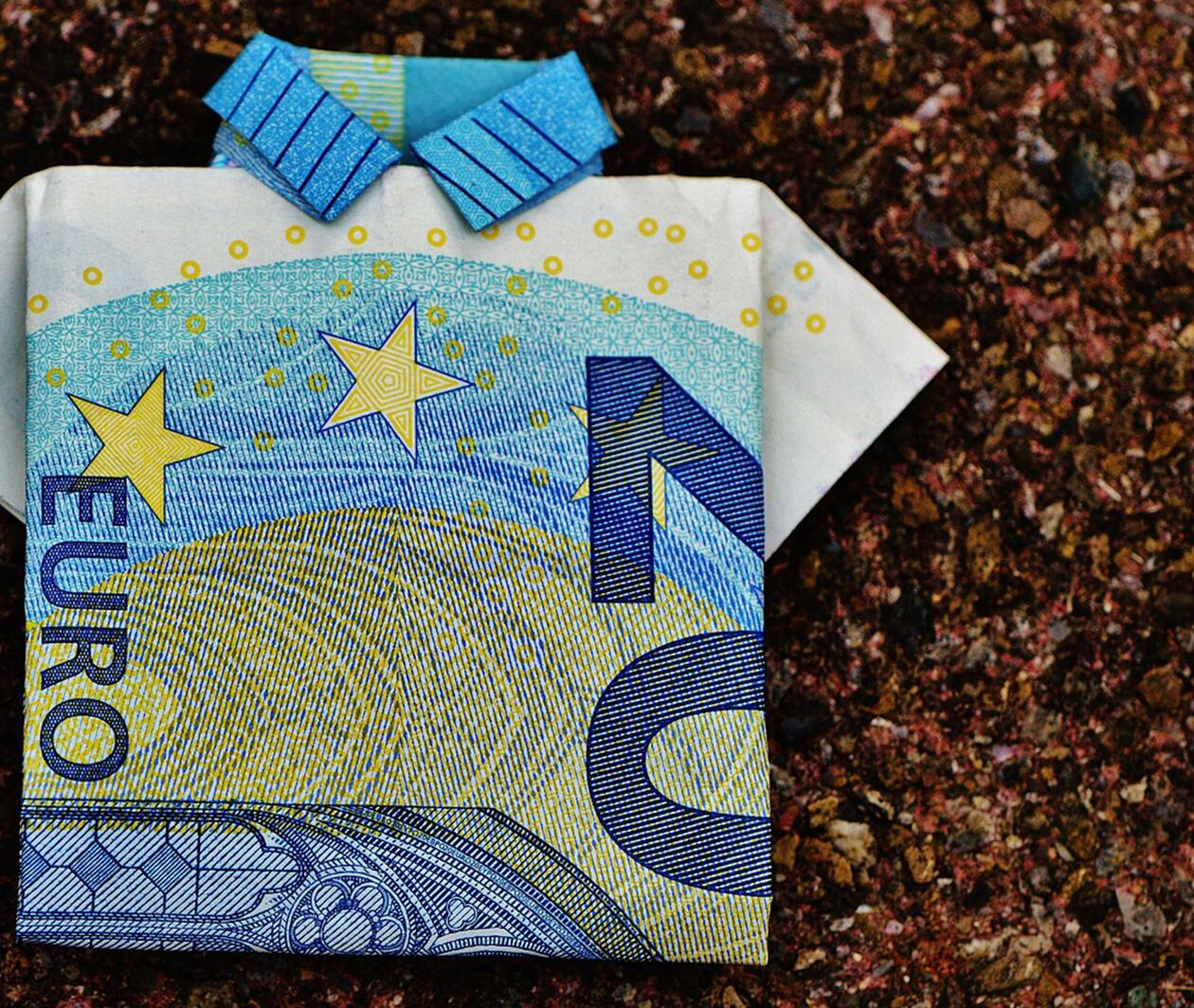 A €20 note folded into the shape of a football shirt