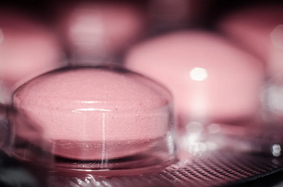 Pink tablets in a plastic blister pack.