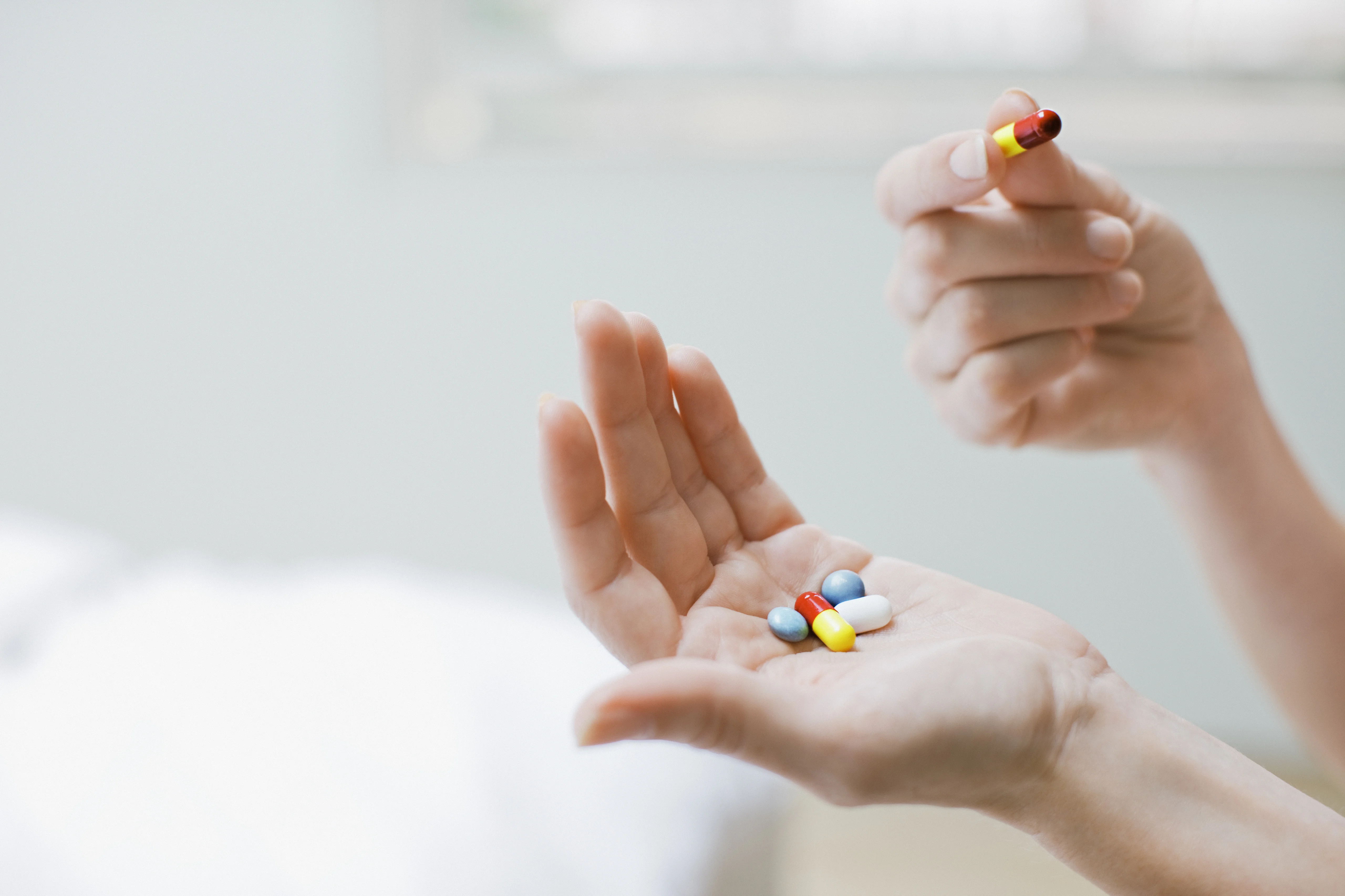 Woman taking vitamins and supplements.