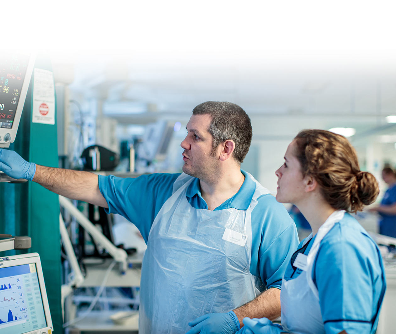 Two medical staff looking at health data in a hospital.