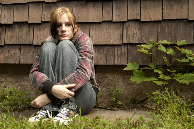 young woman sitting outdoors