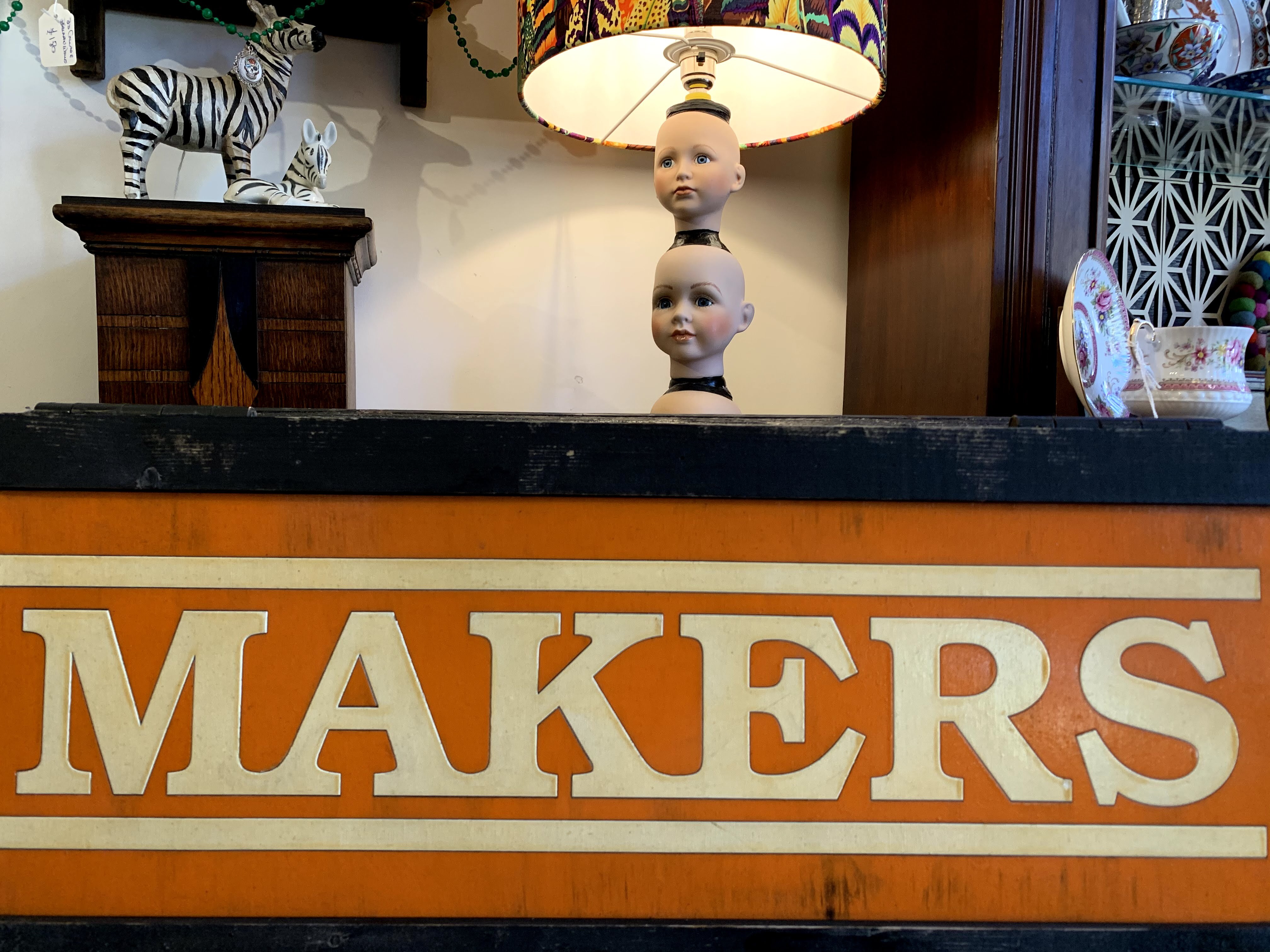 A sign saying 'makers' beneath a homemade lamp