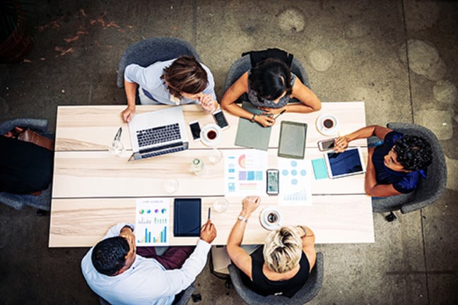 5 people working efficiently at a table