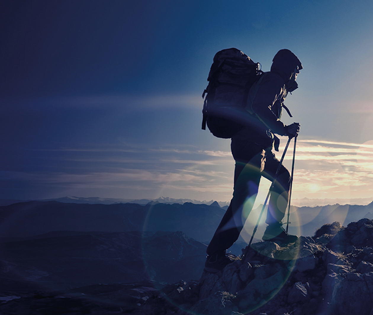 A mountain climber hiking up a peak