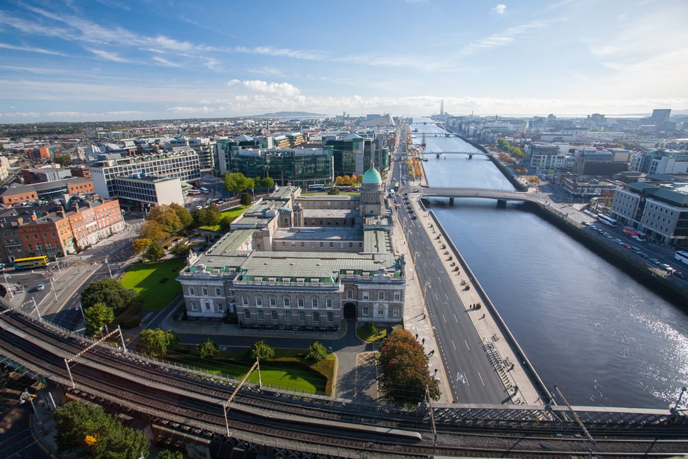 An aerial view of Dublin, Ireland. A large river runs through a busy city.