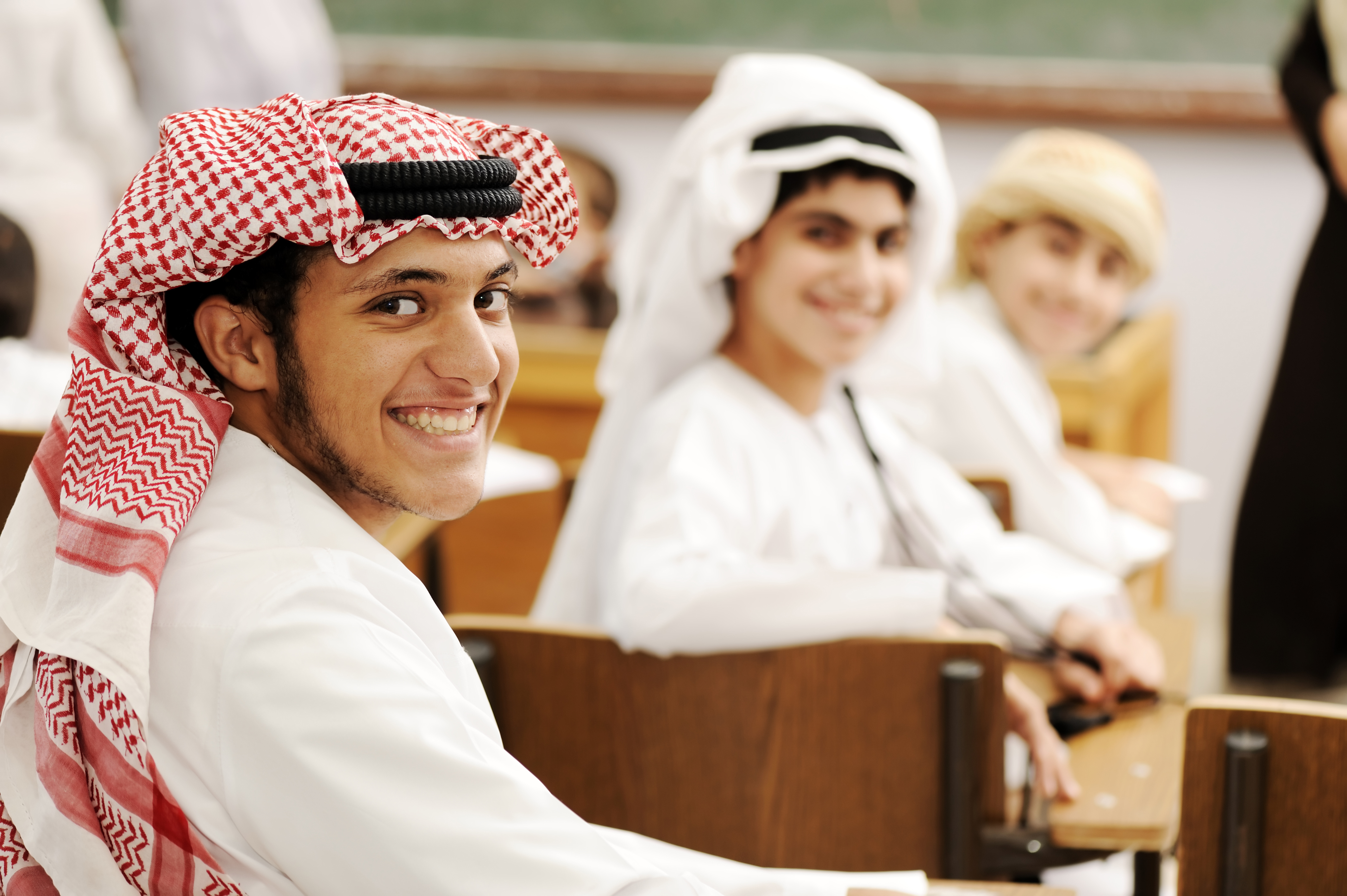 Students in classroom in traditional arabic dress