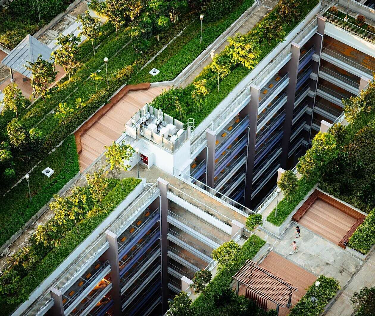 Aerial shot of a residential estate complex with green plants on the roof as a method to develop sustainable building and energy efficiency.