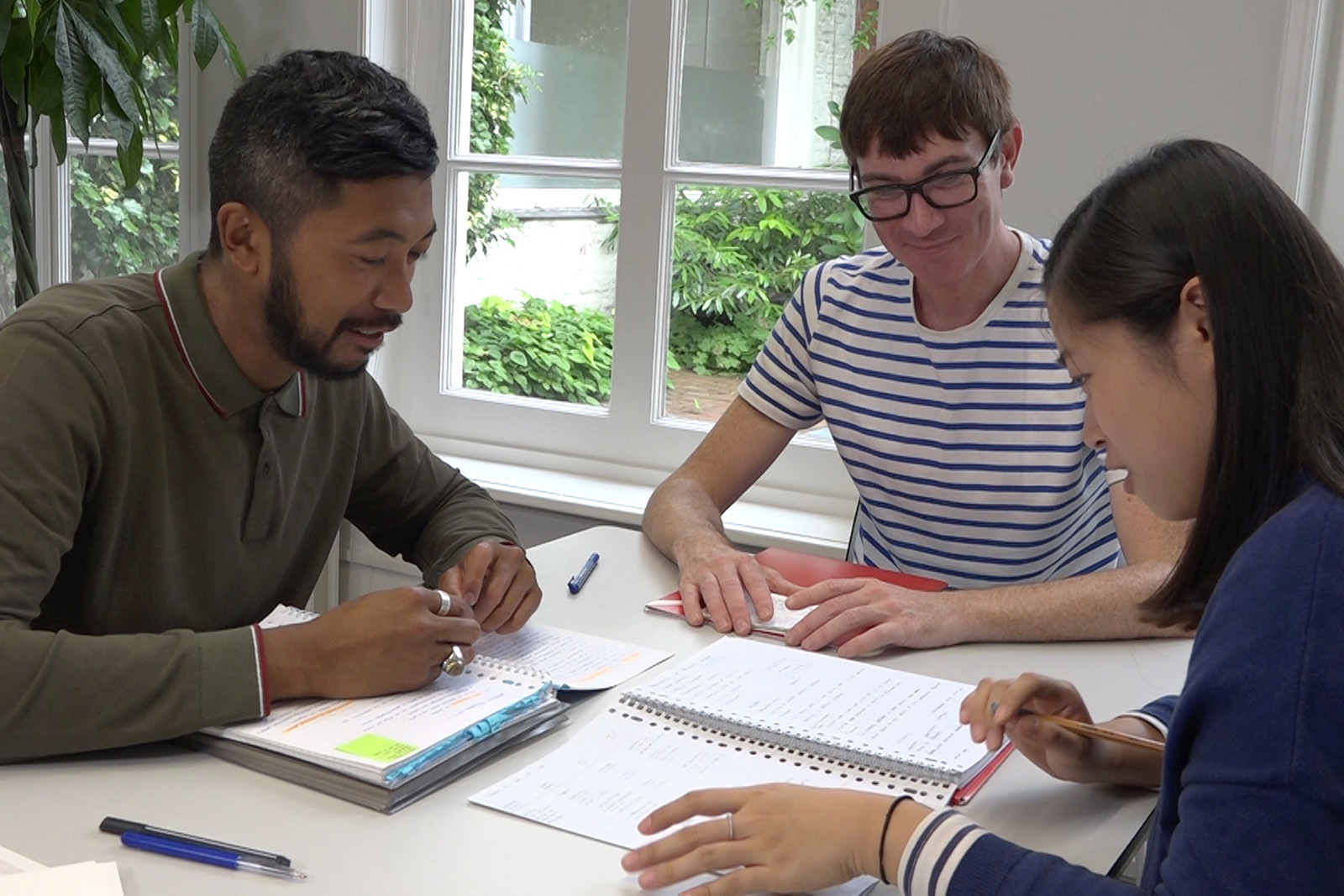 Three students sitting together and studying