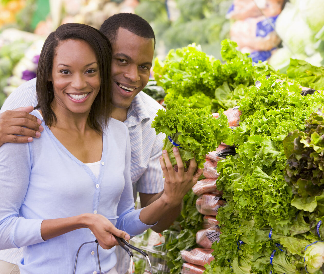 Couple buying fresh nutritional produce in supermarket as part of a healthy and balanced lifestyle 