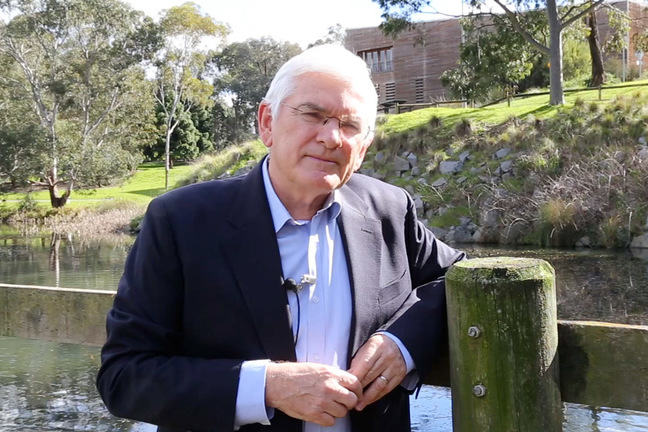 Rob Skinner standing near a lake.