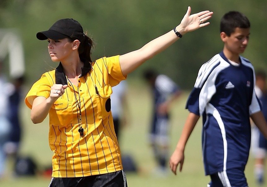 A soccer referee making a ruling