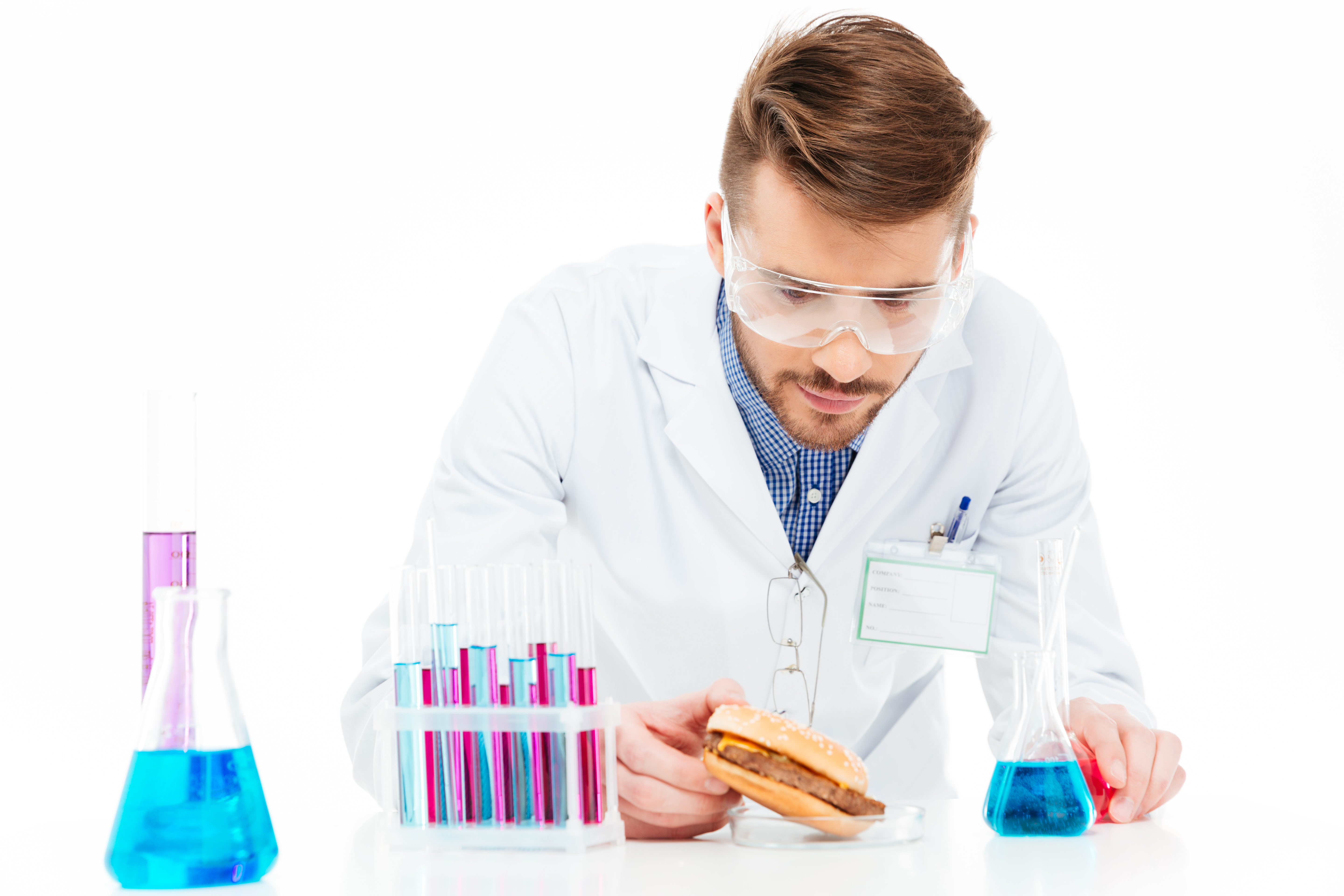 Male chemist holding burger in lab