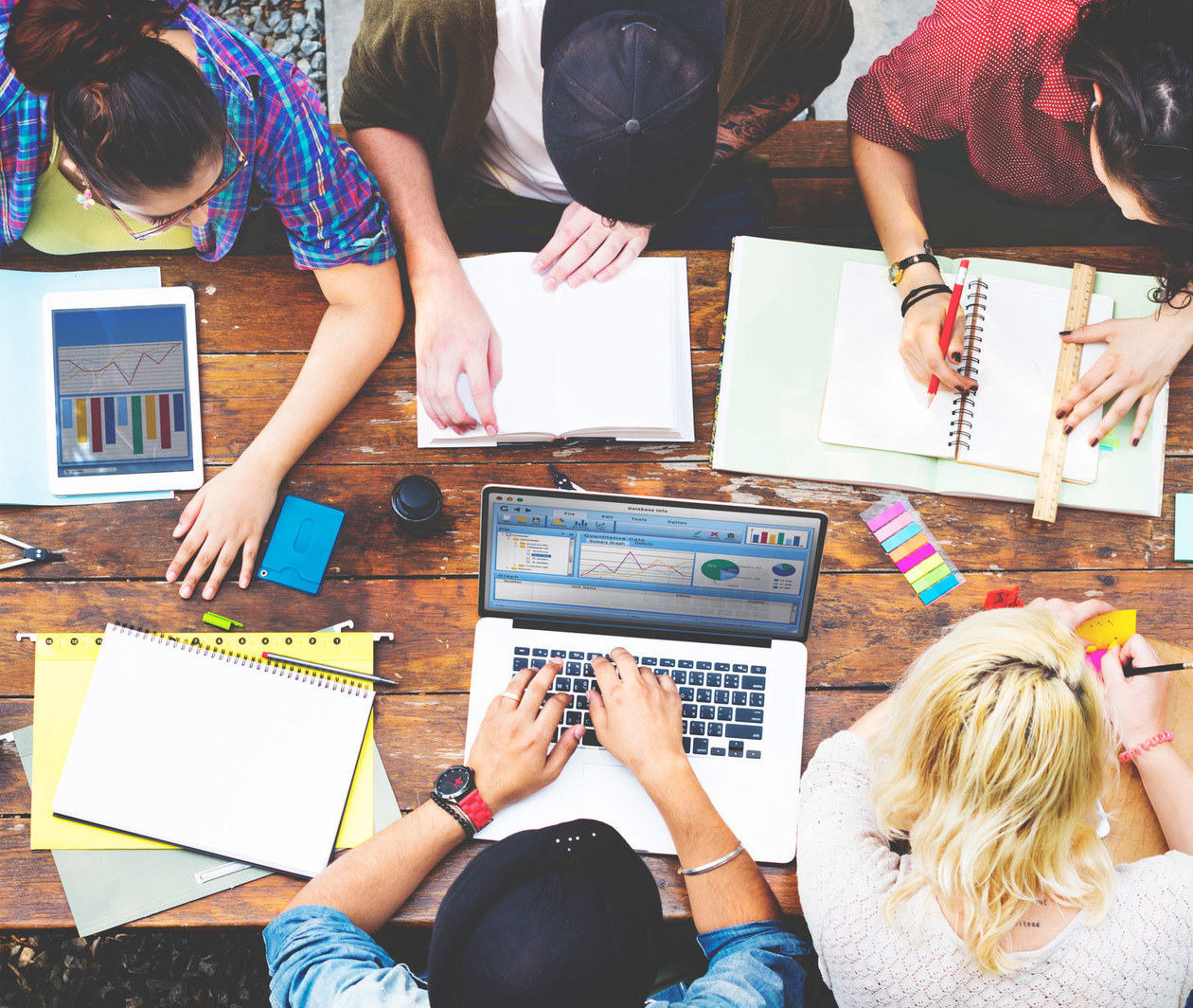 Diversity teamwork brainstorm meeting outside on picnic table