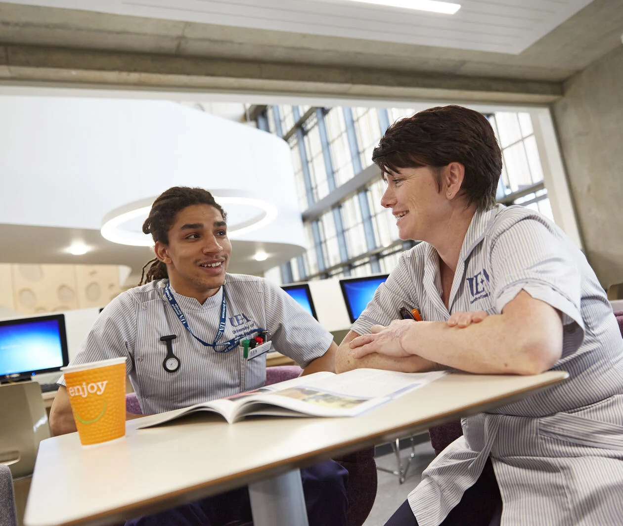 Nursing students sitting around a table chatting