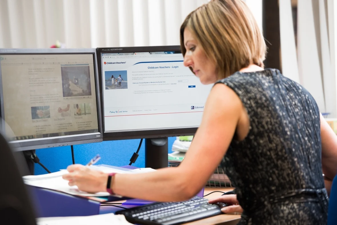 Female sat at a computer writing