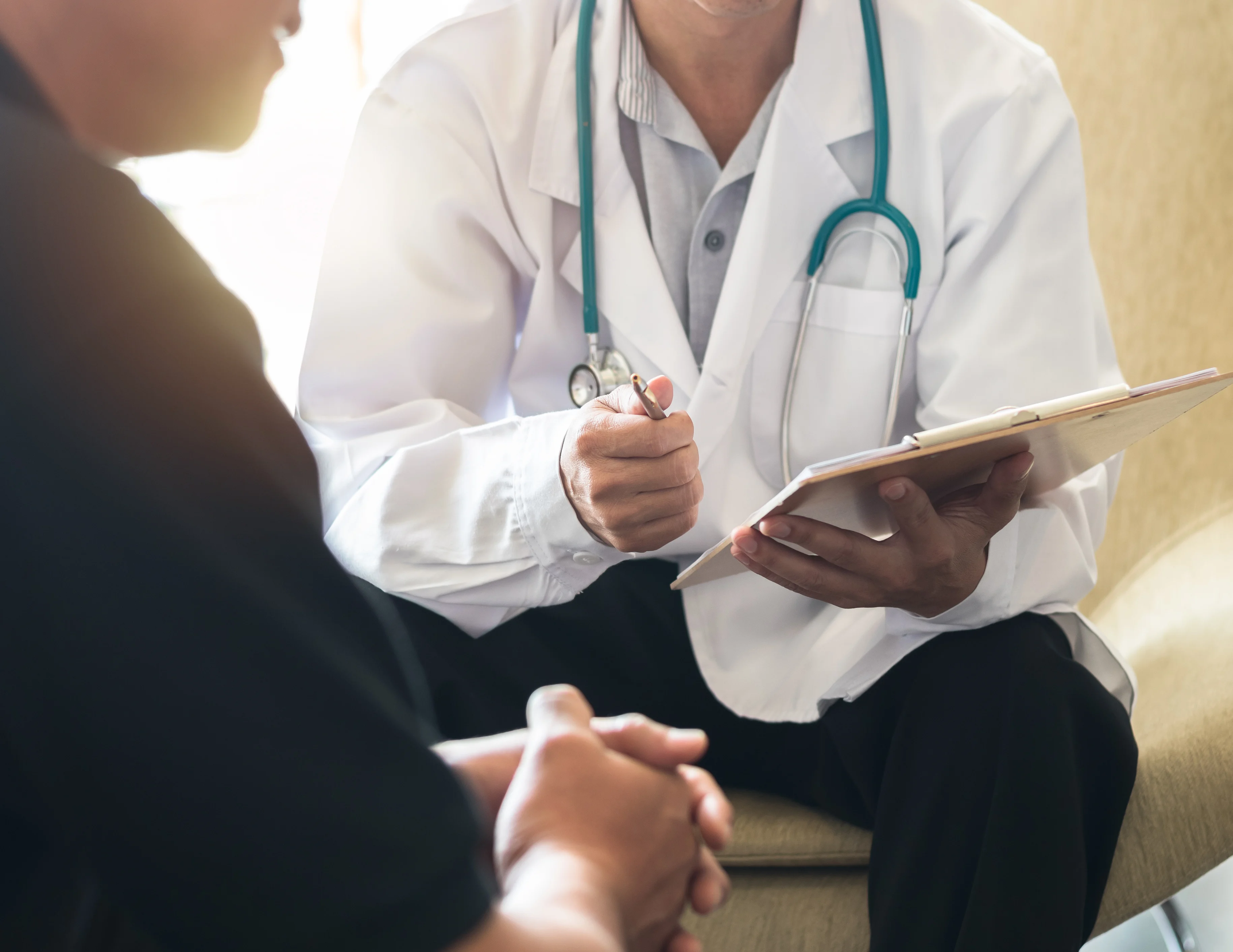 Male doctor working with a male patient having consultation on diagnostic examination